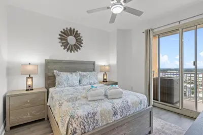 a bedroom with a bed with two towels on it at Treasure Tides–3BR Beachfront Corner Unit sleeps 8 with Stunning Gulf Views! in Panama City Beach