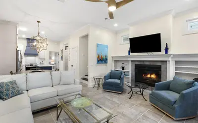 a living room with a couch and a fireplace at Sea Stars by Oversee 30A in Seacrest