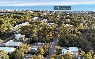 an aerial view of a residential neighborhood with a sign that reads sea sites at Sea Stars by Oversee 30A in Seacrest