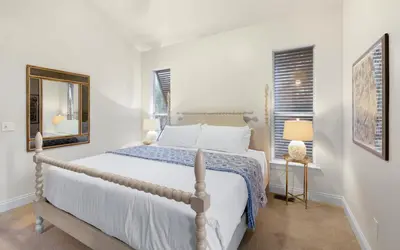 a white bedroom with a bed and a window at Sea Stars by Oversee 30A in Seacrest