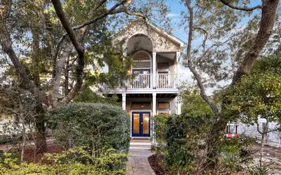 a house with a balcony and a blue door at Sea Stars by Oversee 30A in Seacrest