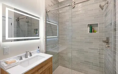 a bathroom with a sink and a glass shower at Sea Stars by Oversee 30A in Seacrest