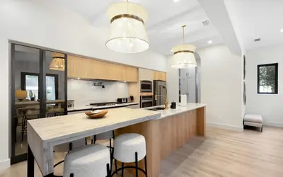 a kitchen with a large island with bar stools at Sapphire Bay by Oversee 30A in Santa Rosa Beach