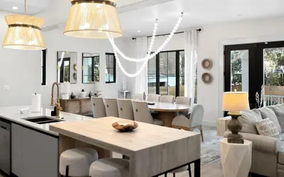 a kitchen and living room with a table and chairs at Sapphire Bay by Oversee 30A in Santa Rosa Beach