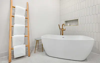 a bathroom with a white tub and a towel rack at Sapphire Bay by Oversee 30A in Santa Rosa Beach