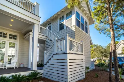 a house with a staircase in front of it at Our Tree House by Oversee 30A in Inlet Beach