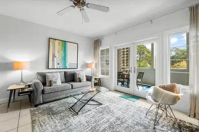 a living room with a couch and a table at 30A - Cassine Station by Panhandle Getaways in Santa Rosa Beach