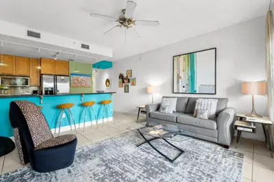 a living room with a couch and a kitchen at 30A - Cassine Station by Panhandle Getaways in Santa Rosa Beach