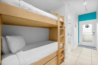 a bunk bed in a room with a hallway at 30A - Cassine Station by Panhandle Getaways in Santa Rosa Beach