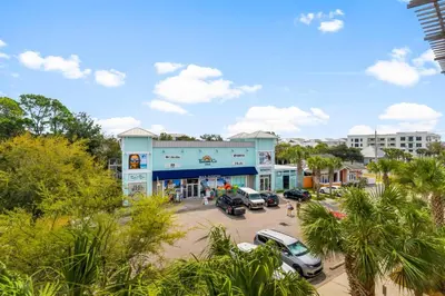 a building with cars parked in a parking lot at 30A - Cassine Station by Panhandle Getaways in Santa Rosa Beach