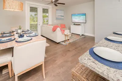 a living room with a table and a couch at Chic Seagrove Retreat- Modern 30A Coastal Living in Santa Rosa Beach