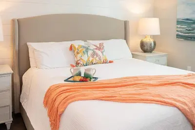 a white bed with a tray of fruit on it at Chic Seagrove Retreat- Modern 30A Coastal Living in Santa Rosa Beach