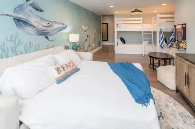 a bedroom with a white bed with a fish mural on the wall at Chic Seagrove Retreat- Modern 30A Coastal Living in Santa Rosa Beach