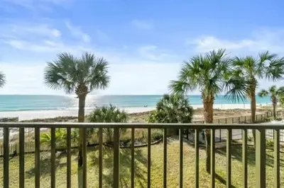 a view of a beach with palm trees and the ocean at Commodore 202 - Thomas Drive Paradise in Panama City Beach