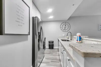 a white kitchen with a refrigerator and a sink at Cassine Way 303 - Seagrove + Sunsets in Santa Rosa Beach