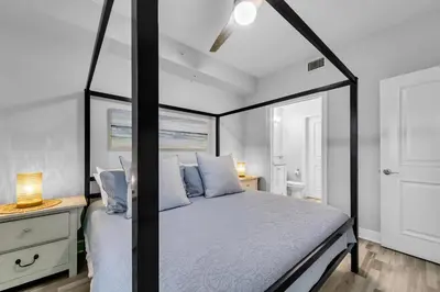 a bedroom with a black and white canopy bed at Cassine Way 303 - Seagrove + Sunsets in Santa Rosa Beach