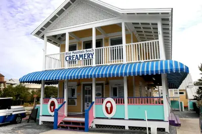 a building with a captain america sign on it at Cassine Way 303 - Seagrove + Sunsets in Santa Rosa Beach