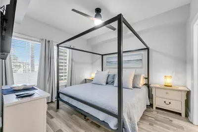 a bedroom with a canopy bed and a desk at Cassine Way 303 - Seagrove + Sunsets in Santa Rosa Beach