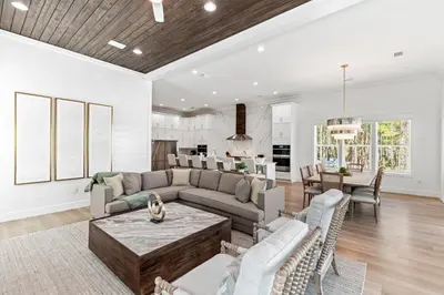 a living room with a couch and a table at Coastal Opulence in Santa Rosa Beach