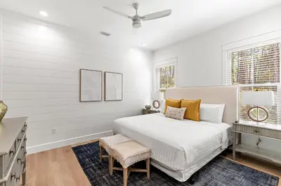 a white bedroom with a bed and a window at Coastal Opulence in Santa Rosa Beach