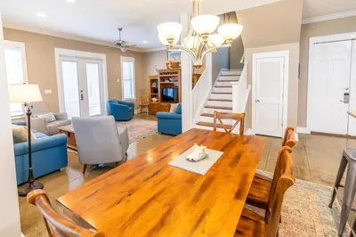 a living room with a wooden table with a cat on it at Blue Paradise in Seagrove Beach