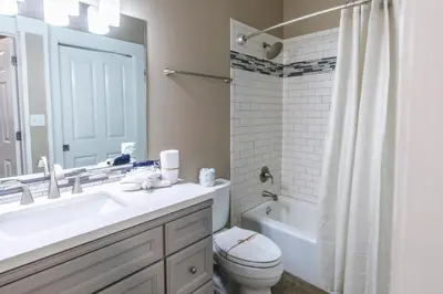 a bathroom with a sink and a toilet and a mirror at Blue Paradise in Seagrove Beach