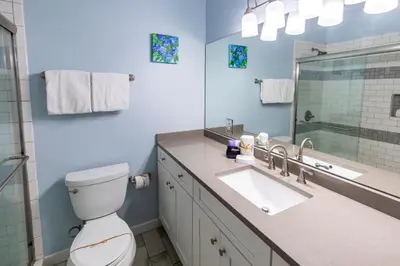 a bathroom with a toilet and a sink and a mirror at Blue Paradise in Seagrove Beach