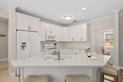 a kitchen with white cabinets and a sink at 30A Cottage Near the Beach with Golf Cart in Inlet Beach