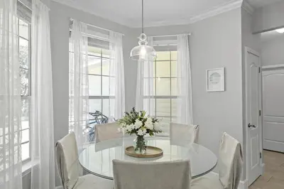 a dining room with a glass table and chairs at 30A Cottage Near the Beach with Golf Cart in Inlet Beach