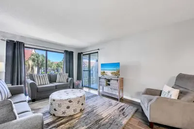 a living room with two couches and a tv at Edgewater Golf Villa 956 in Santa Rosa Beach