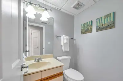 a bathroom with a sink and a toilet and a mirror at Edgewater Golf Villa 956 in Santa Rosa Beach