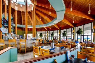 a restaurant with a dining area with tables and chairs at Edgewater Golf Villa 956 in Santa Rosa Beach