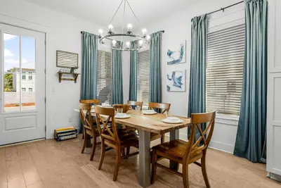 a dining room with a wooden table and chairs at 30A Pet Friendly Beach House - Paradise Valle by Panhandle Getaways in Inlet Beach
