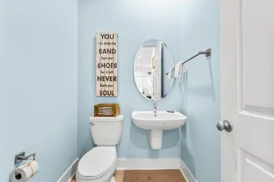 a bathroom with a white toilet and a sink at 30A Pet Friendly Beach House - Paradise Valle by Panhandle Getaways in Inlet Beach
