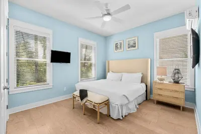 a bedroom with blue walls and a bed and a chair at 30A Pet Friendly Beach House - Paradise Valle by Panhandle Getaways in Inlet Beach