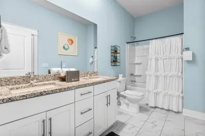 a white bathroom with a toilet and a sink at 30A Pet Friendly Beach House - Paradise Valle by Panhandle Getaways in Inlet Beach
