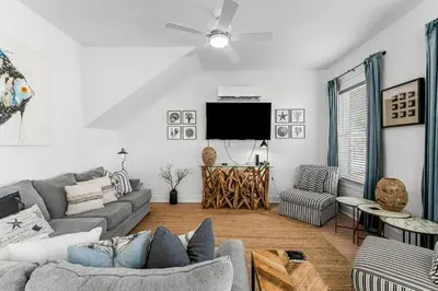 a living room with a couch and a flat screen tv at 30A Pet Friendly Beach House - Paradise Valle by Panhandle Getaways in Inlet Beach