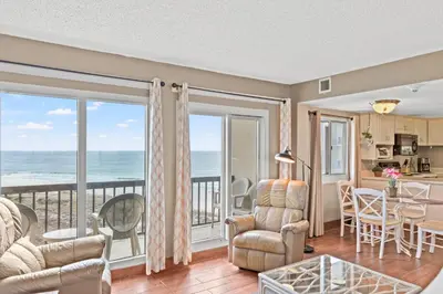 a living room with a view of the ocean at Pinnacle Port A-506 in Carillon Beach