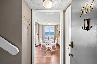 a dining room with a table and a view of the ocean at Pinnacle Port A-506 in Carillon Beach
