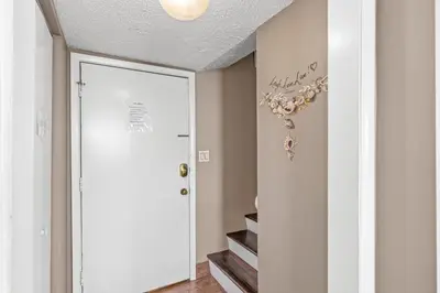 a hallway with a white door and a stairway at Pinnacle Port A-506 in Carillon Beach