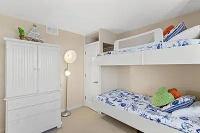 a bedroom with two bunk beds and a closet at Pinnacle Port A-514 in Carillon Beach