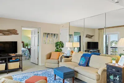 a living room with a couch and a tv at Pinnacle Port A-514 in Carillon Beach