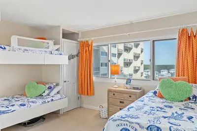 a bedroom with two bunk beds and a window at Pinnacle Port A-514 in Carillon Beach