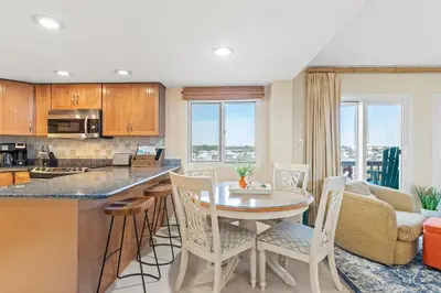 a kitchen and living room with a table and chairs at Pinnacle Port A-514 in Carillon Beach