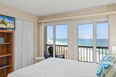 a bedroom with a bed and a view of the ocean at Pinnacle Port A-701 in Carillon Beach