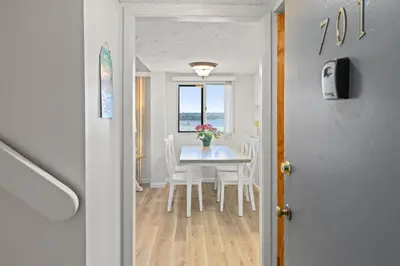 a dining room and kitchen with a table and chairs at Pinnacle Port A-701 in Carillon Beach