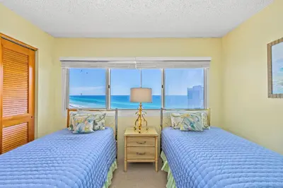 two beds in a bedroom with a view of the ocean at Pinnacle Port Penthouse11 in Carillon Beach