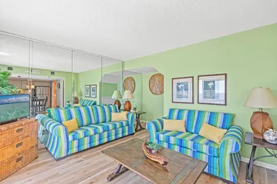 a living room with two couches and a tv at Pinnacle Port Penthouse11 in Carillon Beach