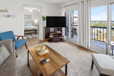 a living room with a couch and a tv at Pinnacle Port Penthouse 15 in Carillon Beach
