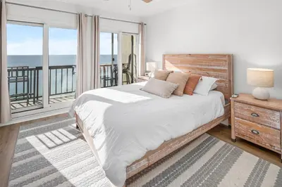 a bedroom with a bed with a view of the ocean at Pinnacle Port Penthouse 15 in Carillon Beach